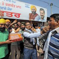 AAP workers distribute sweets in Amritsar