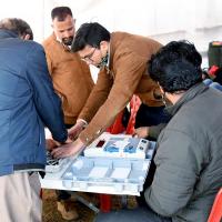 A polling officer checks an EVM in Uttarakhand