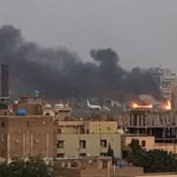 Smoke rises from the burning tarmac at Khartoum airport. Abdullah Abdel Moneim/Reuters