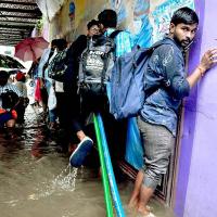 People wade through floodwaters in Chennai on Monday