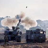 Israeli soldiers fire into Gaza. Amir Cohen/Reuters