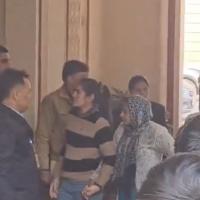 Neelam Devi (in head scarf) brought to court