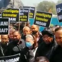 Opposition MPs protest near the Gandhi statue in Parliament