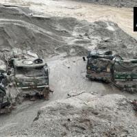 Army trucks covered in the silt of the Teesta river