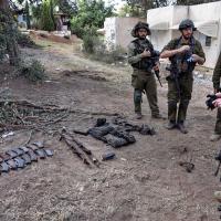 Israeli soldiers collect rifles at a kibbutz. Ronen Zvulun/Reuters