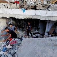 Palestinians in a bombed out building in Gaza. Mohammed Salem/Reuters
