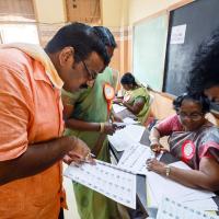 Polling officials check names of voters in the voter list at a polling station in Chennai/ANI Photo