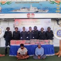 Coast Guard personnel with arrested boat crew members and drugs/Courtesy ICG on X