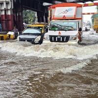 Vehicles wade through a waterlogged King Circle area, in Mumbai/ANI Photo