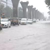 Cars make their way through a flooded BKC