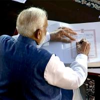 Narendra Modi signs the register after being sworn in as PM, June 9, 2024/ANI Photo