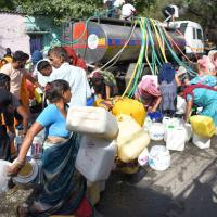 Residents of Vivekanand Camp in Delhi gather to collect drinking water from a tanker/ANI Photo