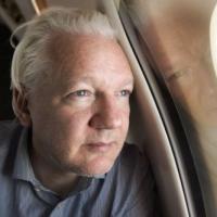 Julian Assange inside the plane at a layover in Bangkok. @WikiLeaks