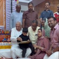 Kerala Governor Arif Mohammed Khan Initiating a boy into writing his first letter at the Vidyarambham ceremony held at Raj Bhavan/Courtesy Kerala Governor on X