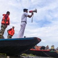 A river traffic patrol in Kolkata warns fishermen