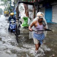 A rickshaw puller wades through a waterlogged road following heavy rainfall as an effect of the 'Dana' cyclone, in Kolkata on Friday./ANI Photo