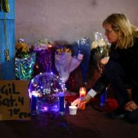 A woman pays homage at a memorial. Pic: Eduardo Munoz/Reuters