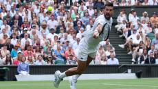 PIX: Djokovic hits century, leads veterans into last 16