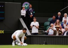 Wimbledon: Djokovic wipes slippery centre court 