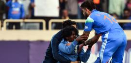 Drama as fan breaches security to touch Kohli's feat!