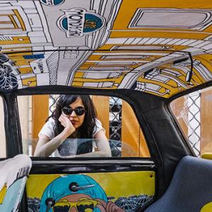 Why is this designer painting taxis?