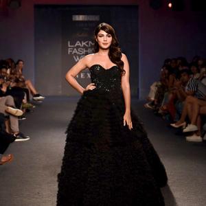 Black magic! Rhea casts a spell in layered gown