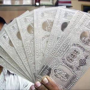 Rupee breaches 64-level, recovers after RBI steps in