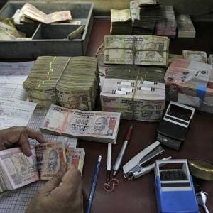 Rupee ends 11 paise down at over 3-week low of 66.93