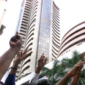 Sensex trims gains on profit-taking; Nifty still over 7K