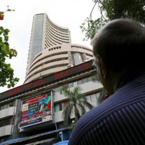 Sensex, Nifty still in red; Infosys soars