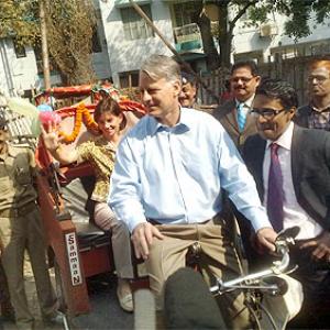 Image: American envoy rides a cycle rickshaw