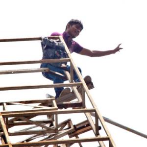 DRAMATIC PIX: Youth threatens suicide over Telangana
