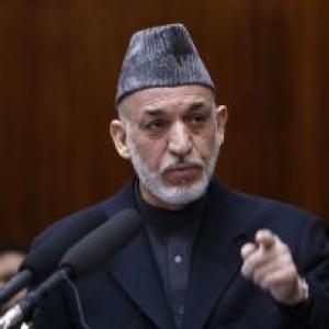 Karzai arrives in India; to seek military aid