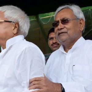 How does Nitish escape Lalu's boa constrictor-like embrace?