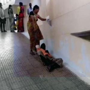 Denied stretcher, woman drags husband on hospital ramp