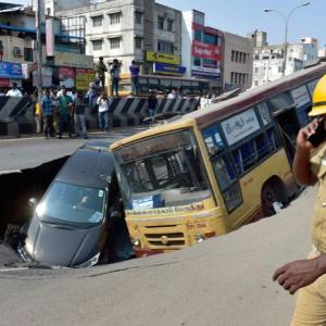 PHOTOS: Bus, car trapped in crater as Chennai road caves in