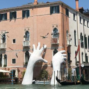 PHOTOS: Why giant hands are emerging from the water in Venice