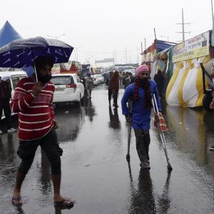Overnight downpour, biting cold fail to deter farmers