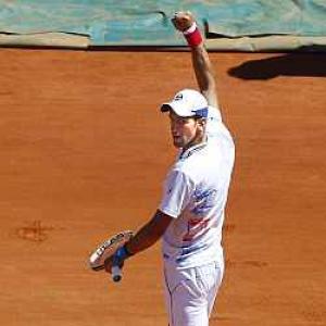 Djokovic switches off from grief to beat Haase