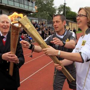 Bannister carries Olympic torch at site of famous mile
