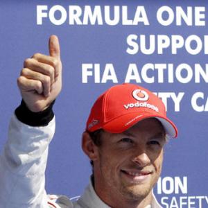 Button puts McLaren on pole in Belgium