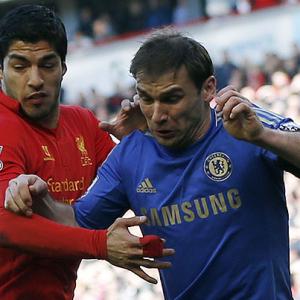 Suarez shows appetite for trouble, bites Chelsea defender