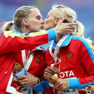 Russia's golden girls protest anti-gay law with podium kiss