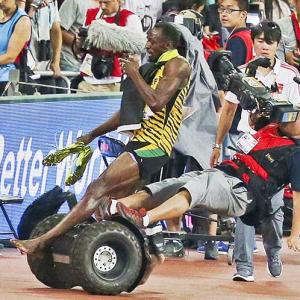 Champ Usain Bolt knocked down by photographer on Segway scooter!
