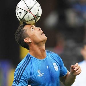 Portugal's Cristiano Ronaldo heads the ball during a team training