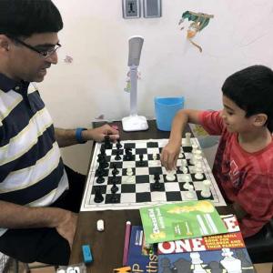 Anand celebrates International Chess Day with son