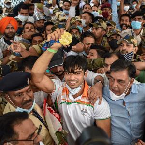 PIX: Frenzy, chaos as India's Olympics heroes return