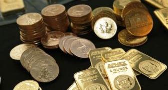 Gold ticks up, heads for second straight weekly gain