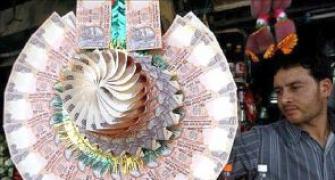 Rupee trims early gains vs dollar; still up 12 paise