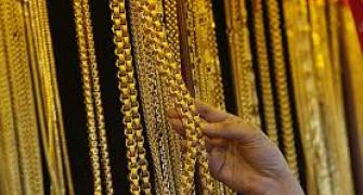 Gold slides to 2-year low on weak global cues, down Rs 300